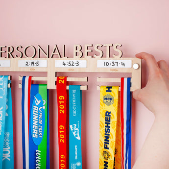 Personalised 'Personal Bests' Medal Hanger, with up to four drywipe sections to record best times for up to four distances, showing the included Brushed Aluminium Wall Mount Fixings