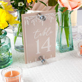 Table number 14 sign with floral decorations on a table.