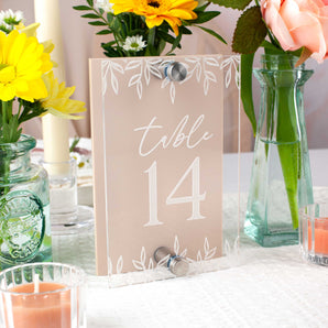 Table number 14 sign with floral decorations on a table.