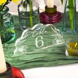 Decorative table number 6 with floral design on a green tablecloth.