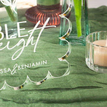 Decorative acrylic plaque with 'Table Eight' on a green tablecloth with candles and vases.