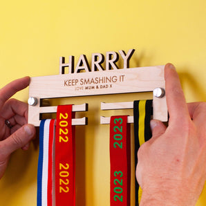Personalised Children's Wooden medal hanger with their name cut out on top, and two lines for  a custom engraved message
