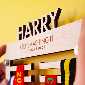 A heartfelt message of support laser engraved onto a Personalised Children's Wooden medal hanger with their name cut out on top.
