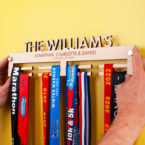Personalised Wooden Family Medal Hanger, featuring the surname and all the family's first names