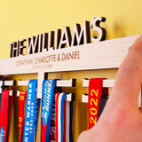 Personalised Wooden Family Medal Hanger, featuring the surname and all the family's first names