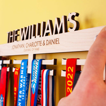 Personalised Wooden Family Medal Hanger, featuring the surname and all the family's first names