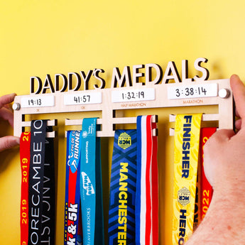 Personalised Wooden Medal Hanger with four dry wipe sections to record personal best times for four events