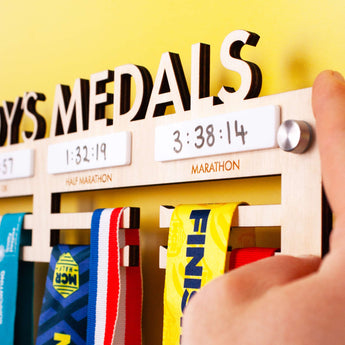 Personalised Wooden Medal Hanger with four dry wipe sections to record personal best times for four events, and Brushed Aluminium Wall Mount Fixings