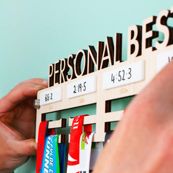 Personalised 'Personal Bests' Medal Hanger, with up to four drywipe sections to record best times  for up to four distances