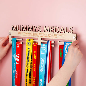 Laser Cut and Engraved Personalised Medal hanger with 'Mummy's Medals' on top, with a cute message engraved over two lines