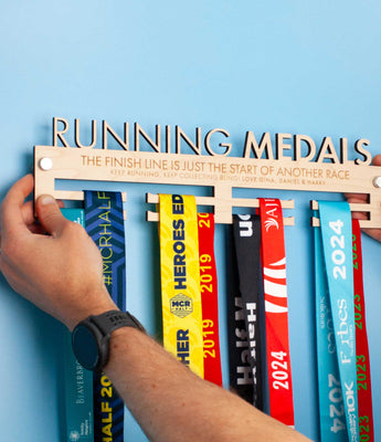 Personalised Wooden Medal Hanger that reads 'RUNNING MEDALS' cut out on the top line and 'THE FINISH LINE IS JUST THE START OF ANOTHER RACE' engraved on the next line 