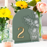 Decorative table number with floral design on a table with flowers and candles