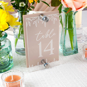 Table number 14 sign with floral decorations on a table.