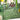 Clear acrylic table number with 'Table eight' and names on a green tablecloth with floral and candle decorations.